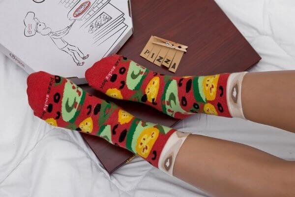 Pizza box and a person wearing pizza socks.